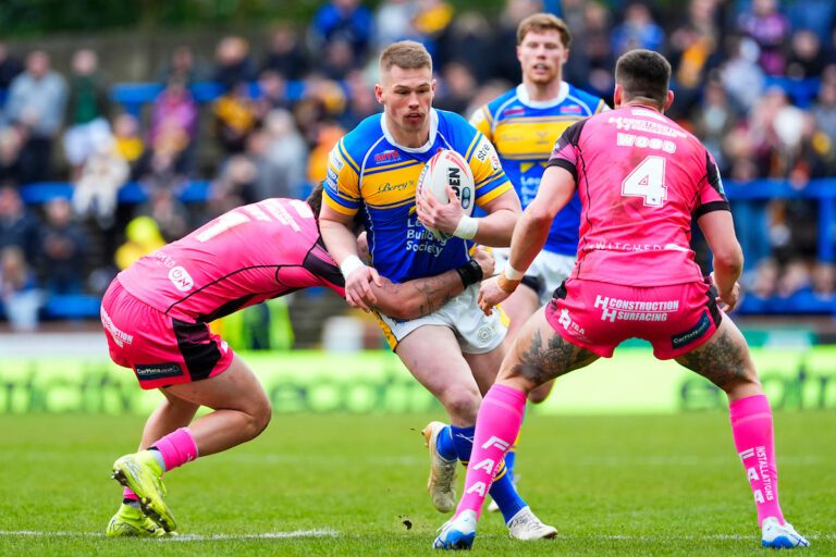 Picture by Olly Hassell/SWpix.com - 02/03/2025 - Rugby League - Betfred Super League Round 3 - Leeds Rhinos v Castleford Tigers - AMT Headingley, Leeds, England - Tom Holroyd of Leeds is tackled by Tex Hoy of Castleford