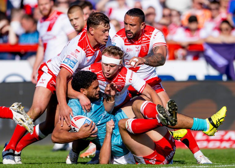 Picture by Allan McKenzie/SWpix.com - 17/05/2025 - Rugby League - Betfred Super League Round 11 - Hull KR v Huddersfield Giants - Sewell Group Craven Park, Hull, England - Huddersfield's Taane Milne is tackled by Hull KR's Jai Whitbread, Jez LItten & Elliot MInchella.