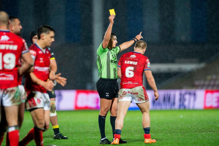 Picture by Allan McKenzie/SWpix.com - 12/02/2026 - Rugby League - Betfred Super League Round 1 - York Knights v Hull KR - LNER Community Stadium, York, England - Referee Liam Rush yellow cards Hull KR's Mikey Lewis after a tripping incident on York's captain Liam Harris.